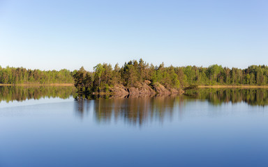 rocky island on a forest lake