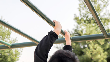 A boy's hand hanging with a cloud ladder.