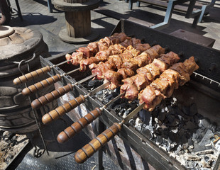Raw meat is prepared on skewers grilled barbecue on charcoal