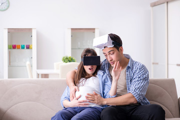 Young couple trying virtual reality glasses goggles