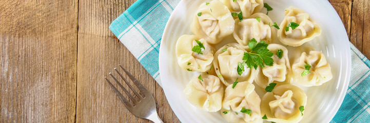 Homemade ready dumplings on an old wooden table.
