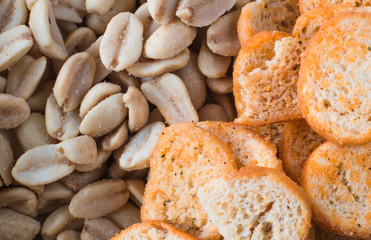 Background of roasted peanuts and crackers. Texture. close-up