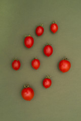 Red ripe tomatoes on a green background