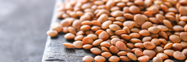 Raw red lentils on a wooden board. Superfood.