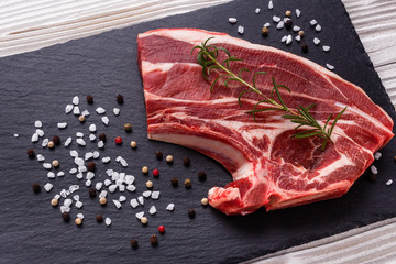 fresh lamb meat on a textured stone plate © Narsil