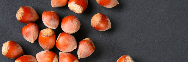 Top view of roasted peeled hazelnuts on a saturated black background.Snacks. Copy space.