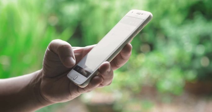 Close up hand using smartphone touching a display screen , 4K Dci resolution