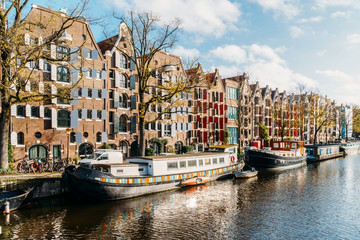 Fototapeta na wymiar Beautiful Architecture Of Dutch Houses and Houseboats On Amsterdam Canal In Autumn