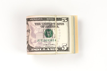 Stack of USA 5 dollars isolated on white background.