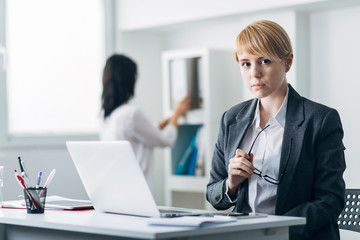 Fototapeta premium Young woman in office