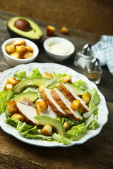 Grilled chicken Caesar salad with avocado