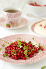 A useful breakfast of strawberries, rice porridge and tea. Rustic style.
