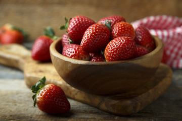 Fresh strawberry in wooden bowl