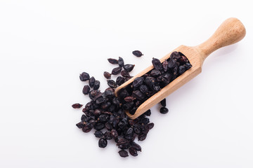 dried barberry berries on the rustic background