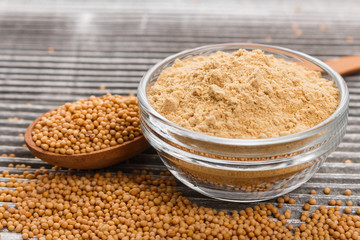 mustard in a bowl on a rustic background