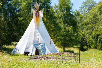 white teepee indian tent and wooden skeleton made for indian saunain.