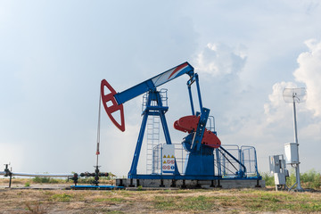 Working oil rig in a cornfield