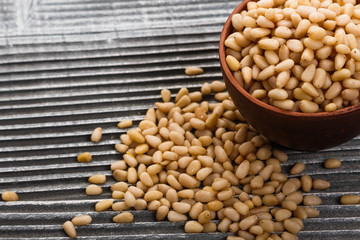 peeled pine nuts on a rustic background