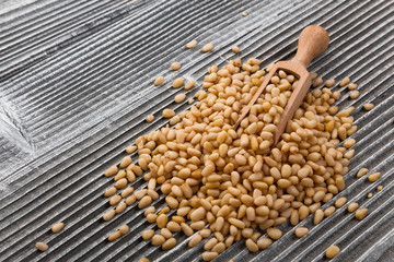 peeled pine nuts on a rustic background