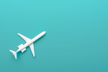 Toy plane on turquoise background