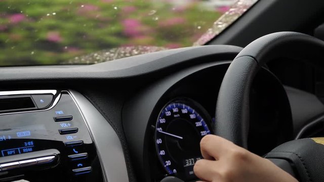one person driving car in country road, hand control steering wheel