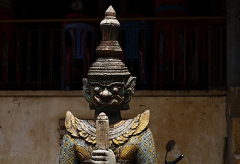 Spiritual protector statue from wood in buddhist pagoda. Wooden statue of warrior. Khmer arts and...