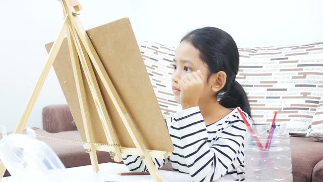 Asian little girl drawing and painting paper art for education concept