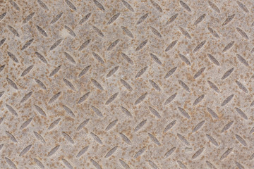 Industrial wallpaper of functional anti-slip metal diamond plate and rough raised surface pattern. Creative background macro photography of construction for catwalks, stairs, walkway.