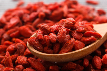 dried goji berries on a wooden rustic background