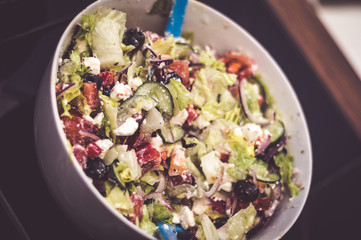 Fresh mixed vegetables salad in a bowl. Selective dark focus
