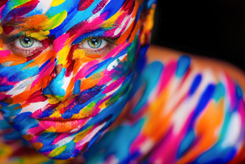 Portrait of the bright beautiful girl with art colorful make-up and bodyart