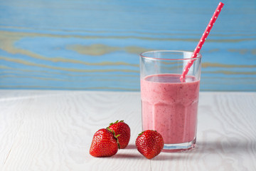 Glasses of milkshakes with chocolate, strawberry, banana flavor, with ice cream on wooden blue and white background. Sweet drinks for summer concept. Shakes and smoothies. Milk shake and cocktail.