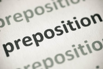 Fototapeta premium word preposition printed on paper macro