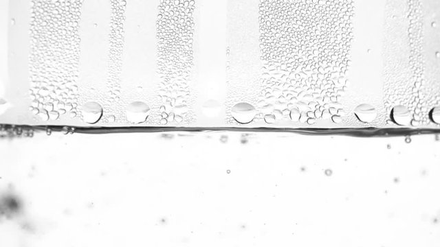 Water boils in kettle. White background. Close up. Slow motion