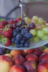 Fresh summer fruits. Organic and natural fruit on tray. Fresh grapes, cheaches, plums and strawberry. Healthy eating.