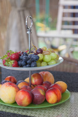 Fresh summer fruits. Organic and natural fruit on tray. Fresh grapes, cheaches, plums and strawberry. Healthy eating.