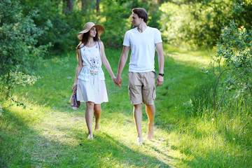 Fototapeta na wymiar Young couple walking in the woods