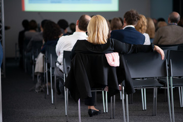audience listens at business meeting, business presentation, conference