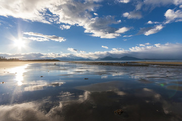Reflection of sky in sandy beach of Alaska. Near Homer.