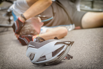 Naklejka premium Bicycle accident, cyclist lying on the road