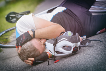 Bicycle accident, cyclist lying on the road
