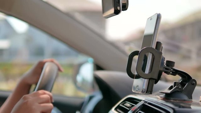 Hands of woman using smartphone in a car for transport application futuristic and technology concept 