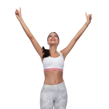 fitness woman pointing fingers and looking up celebrating