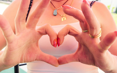 Woman show heart with hands, making heart of fingers