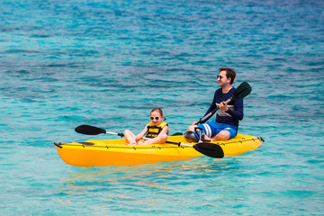 Family kayaking at tropical ocean