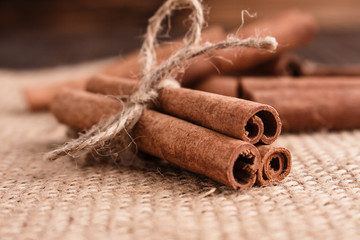 Cinnamon essential oil on a wooden background