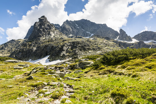 A natural wild and raw landscape of mountain peaks.