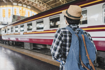 Fototapeta premium Back view Asian man bag pack tourist in railway station at Thailand.