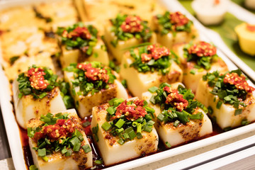 Spicy tofu with sichuan pepper and herbs in soy sauce