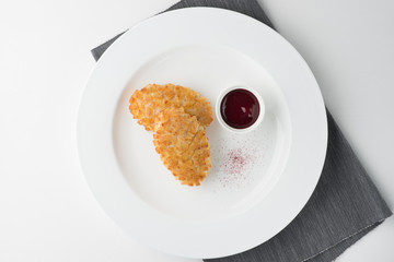 Pozharsky cutlets from breading chicken with sauce and decoration on white plate. top view